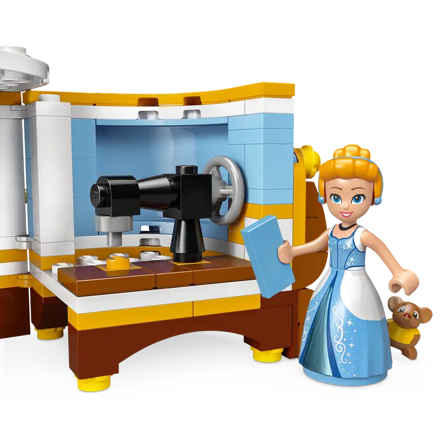 Cinderella Lego set. Cinderella in blue dress, holding a book, next to a sewing machine, and a small teddy bear.