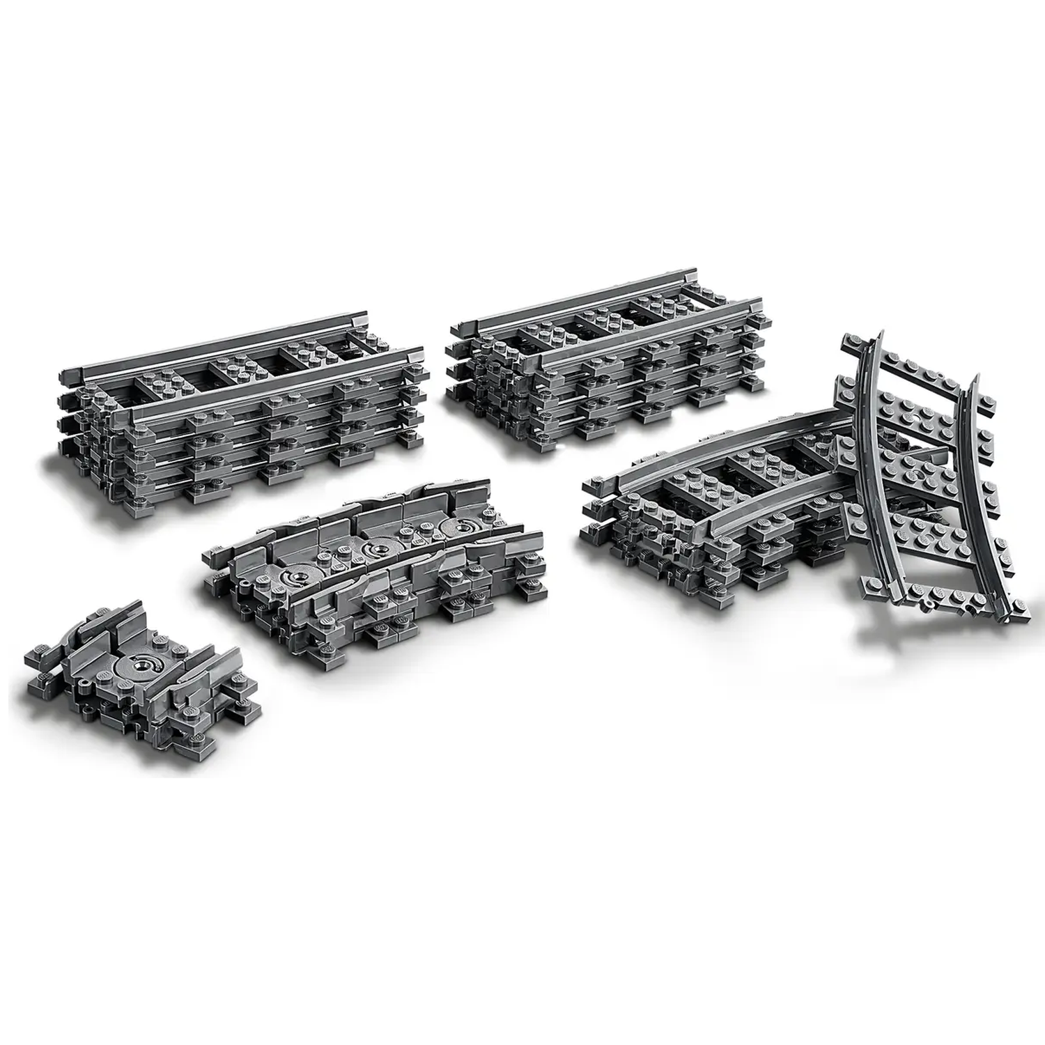 Several stacks of gray Lego train tracks, including straight and curved pieces, are arranged on a white surface.