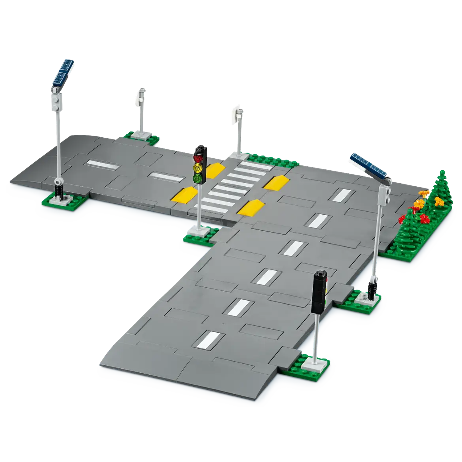 Toy city intersection with crosswalk, traffic lights, street lights, and solar panels. Gray roads and green patches. 