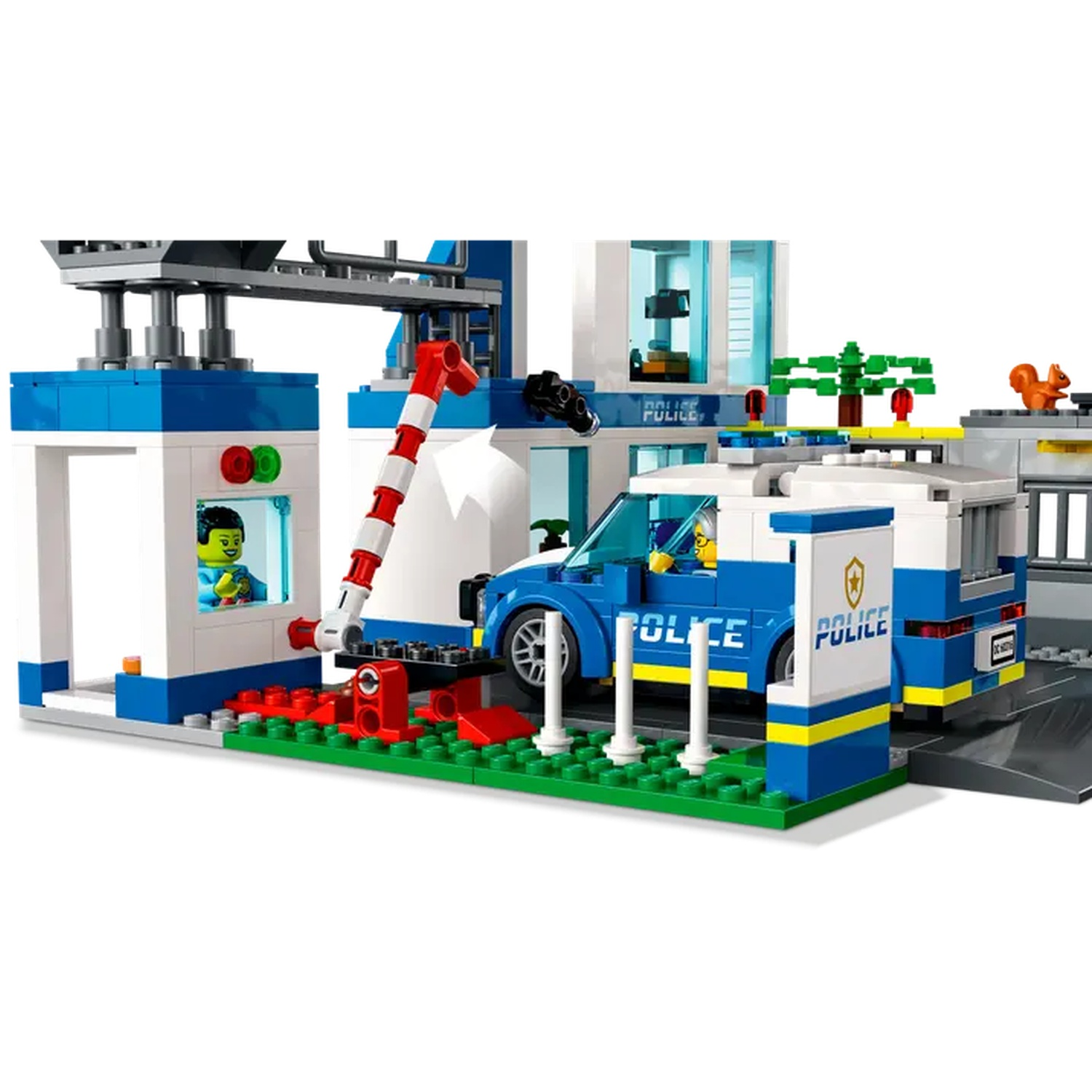 A Lego police station set. Includes a blue and white police car, a building with a barrier, and figures of people.