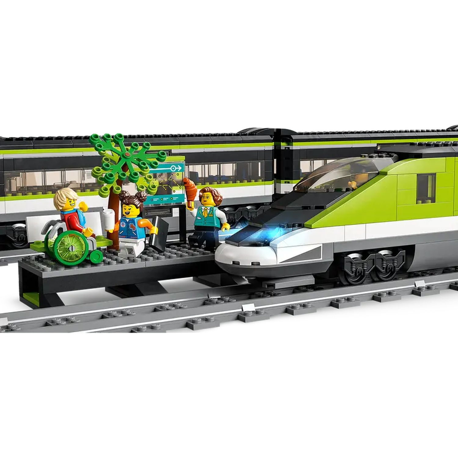 Lego train set. Green and black train with passengers on a platform. Includes a person in a wheelchair and a small tree.
