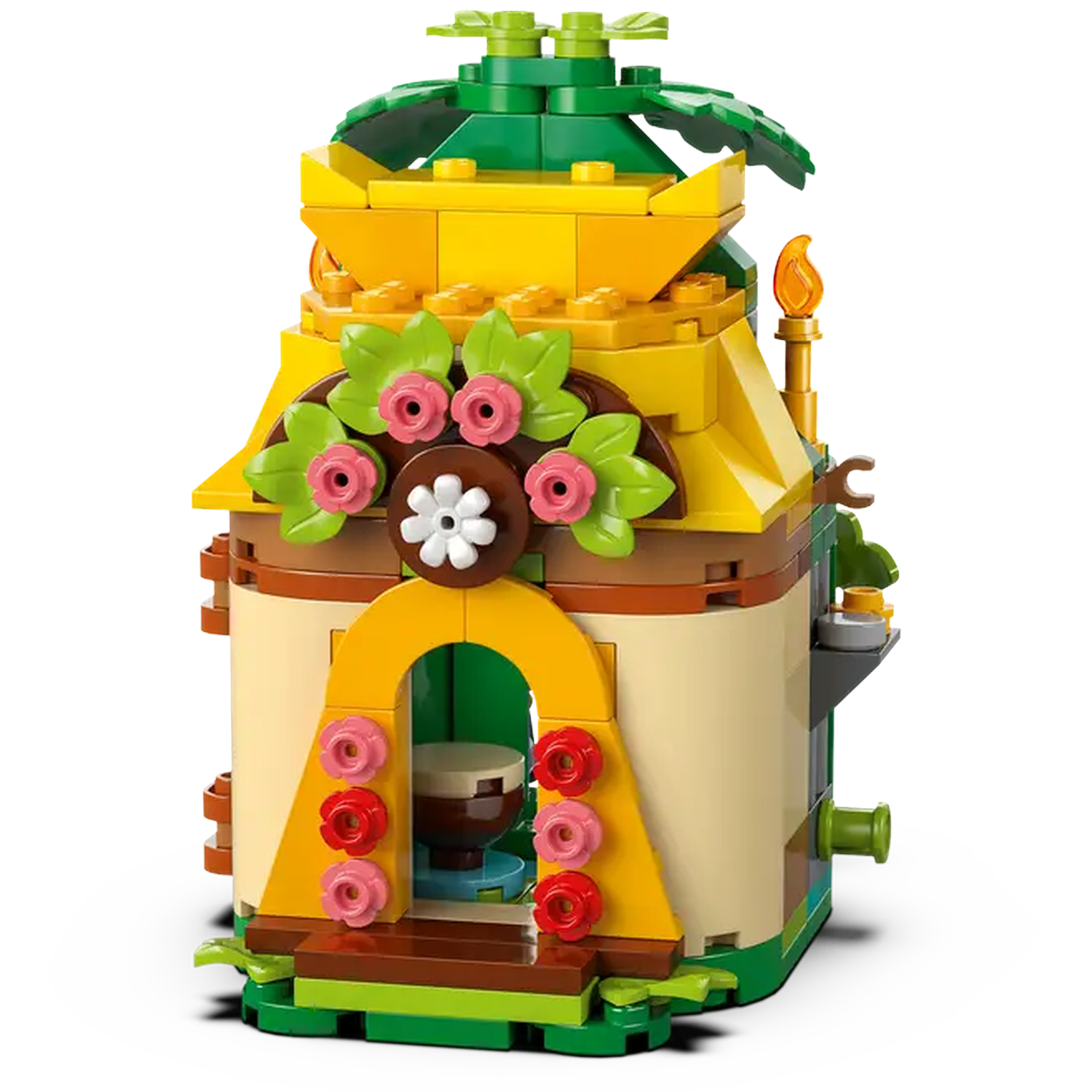 A colorful Lego house. It has a yellow roof, brown walls, and is decorated with flowers and green leaves. There is a torch on the side.
