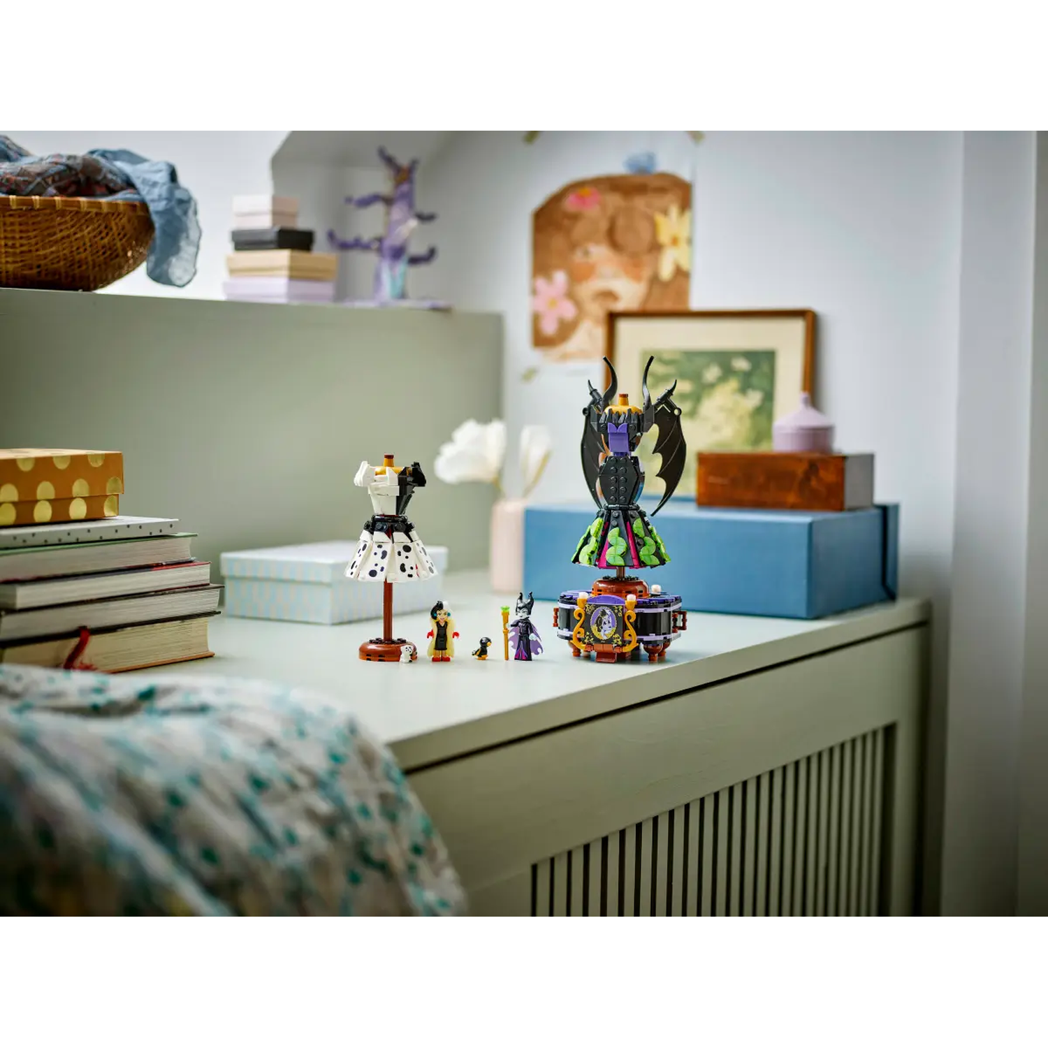 A desk with Lego figures. A dress form, a rotating figure with wings, and several other figures are visible.
