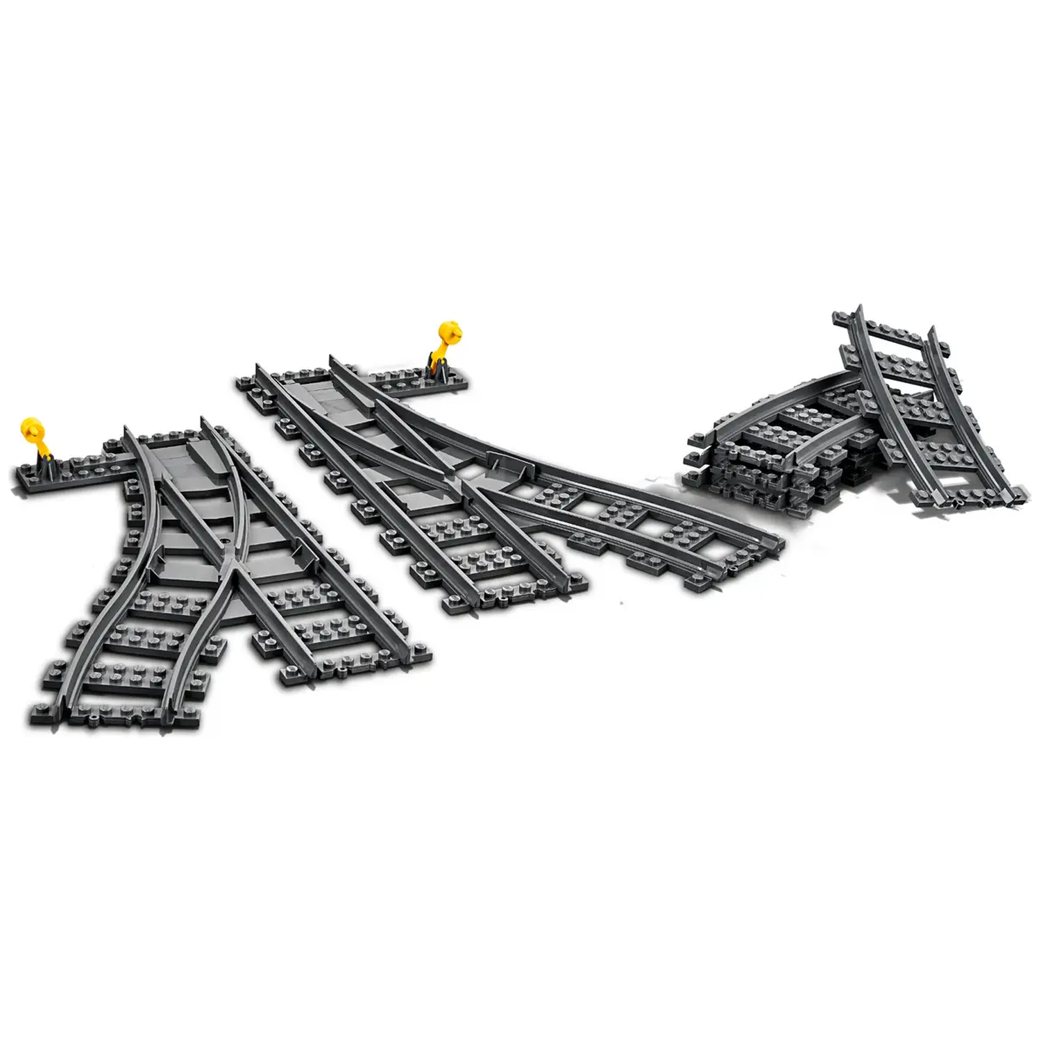 Several gray Lego train tracks are scattered on a white background. Yellow levers are attached to some tracks, and a stack of tracks.