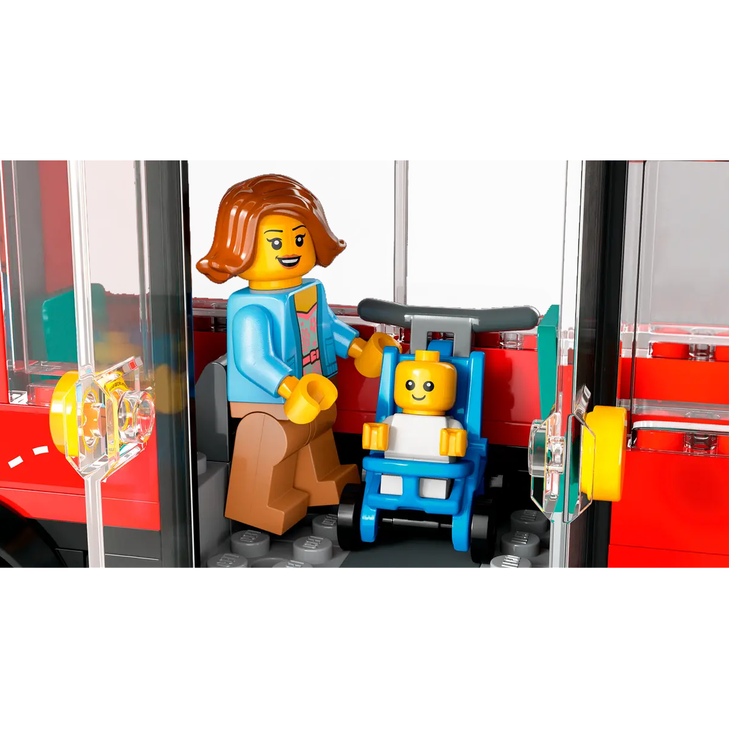 A Lego figure, woman, and baby in a stroller are inside a red bus. The woman is holding the stroller.