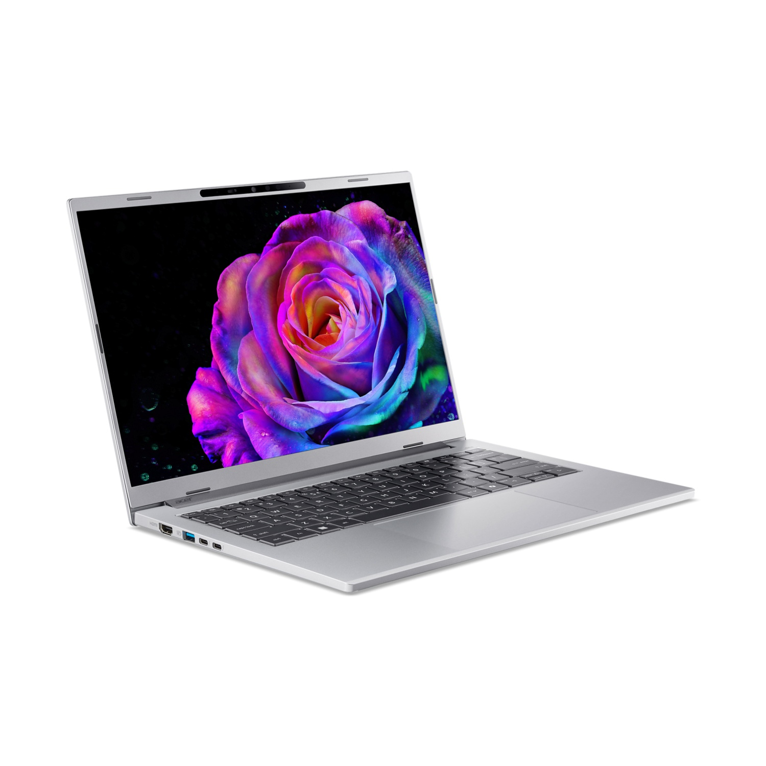 Laptop argento aperto, schermo mostra una rosa colorata su sfondo nero. Tastiera visibile. Sfondo bianco.