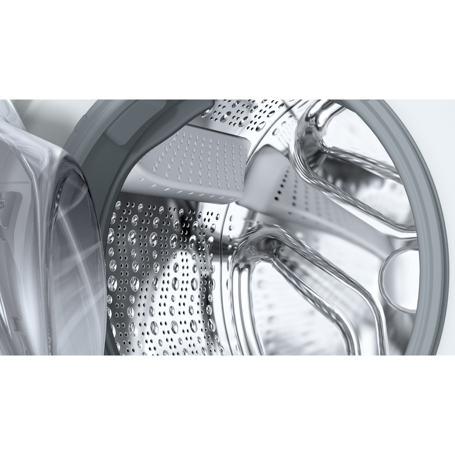 Close-up van een wasmachinetrommel. Zilveren roestvrijstalen interieur met circulair patroon. Grijze rubberen afdichting.