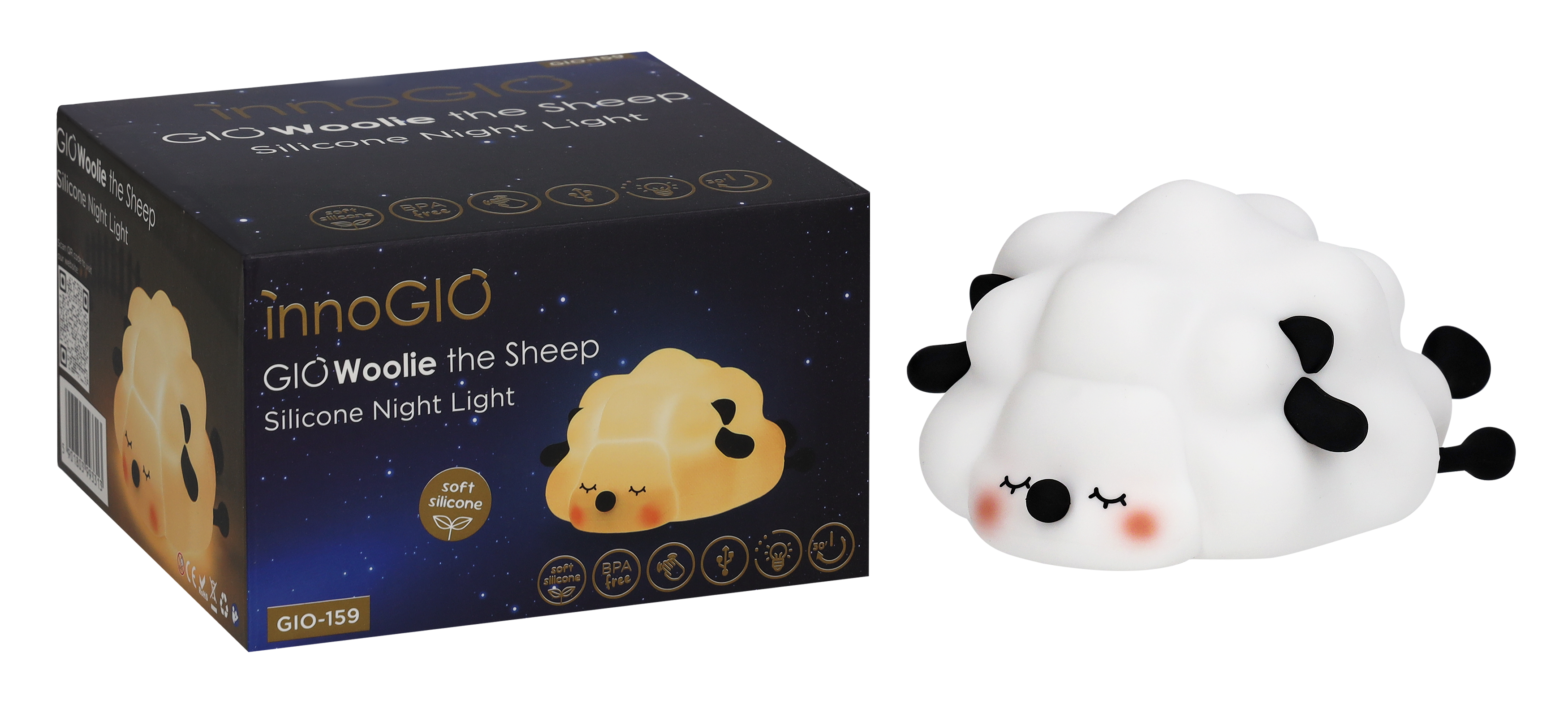 Biała lampka nocna w kształcie owcy z czarnymi akcentami i pudełko z tym samym wzorem. Na pudełku napis 'GIO Woolie the Sheep'.