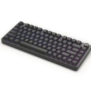 Un teclado negro rectangular con teclas moradas iluminadas sobre un fondo blanco. El teclado tiene una perilla de volumen.