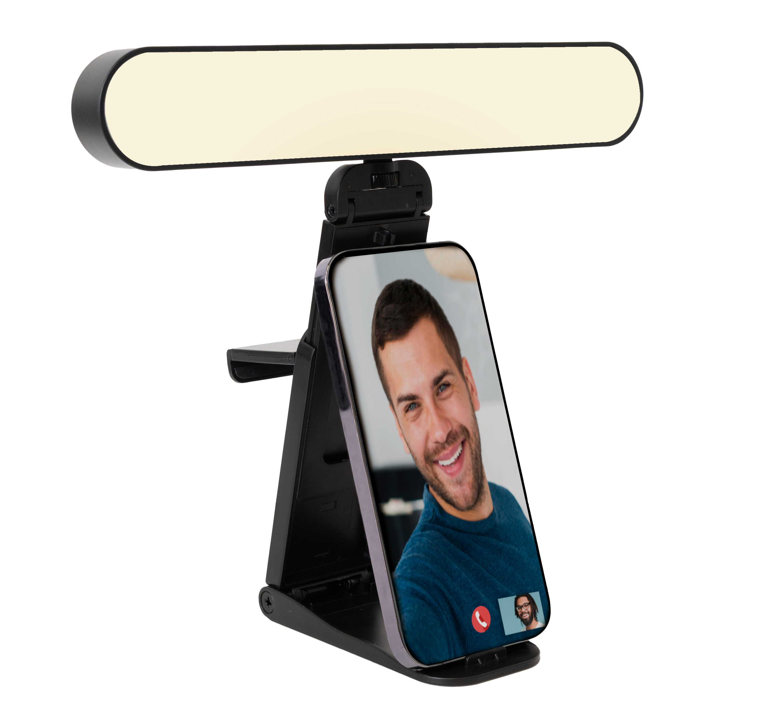 Eine schwarze Schreibtischlampe mit einem Telefon, das einen Videoanruf zeigt. Ein Mann lächelt auf dem Telefonbildschirm.