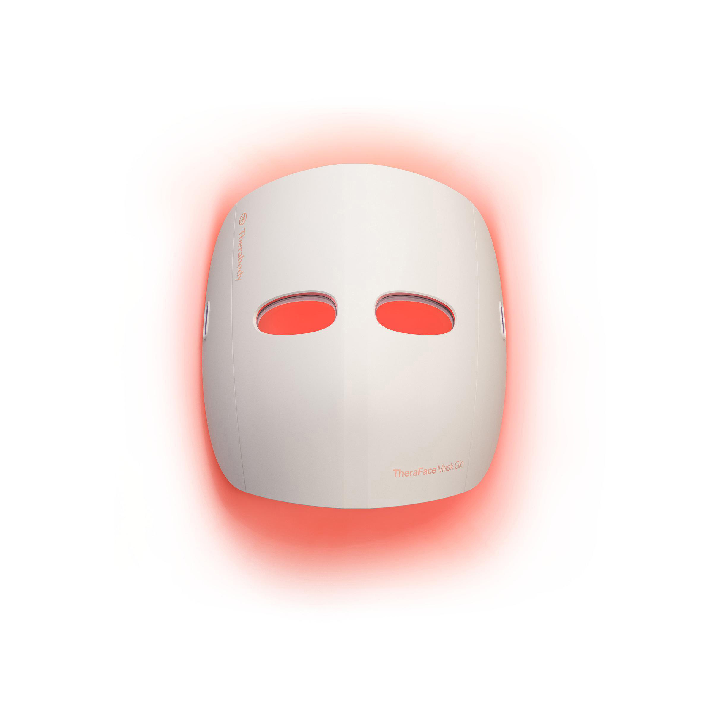 Eine weiße Gesichtsmaske mit zwei Augenlöchern, die mit rotem Licht beleuchtet sind, der Hintergrund ist weiß.