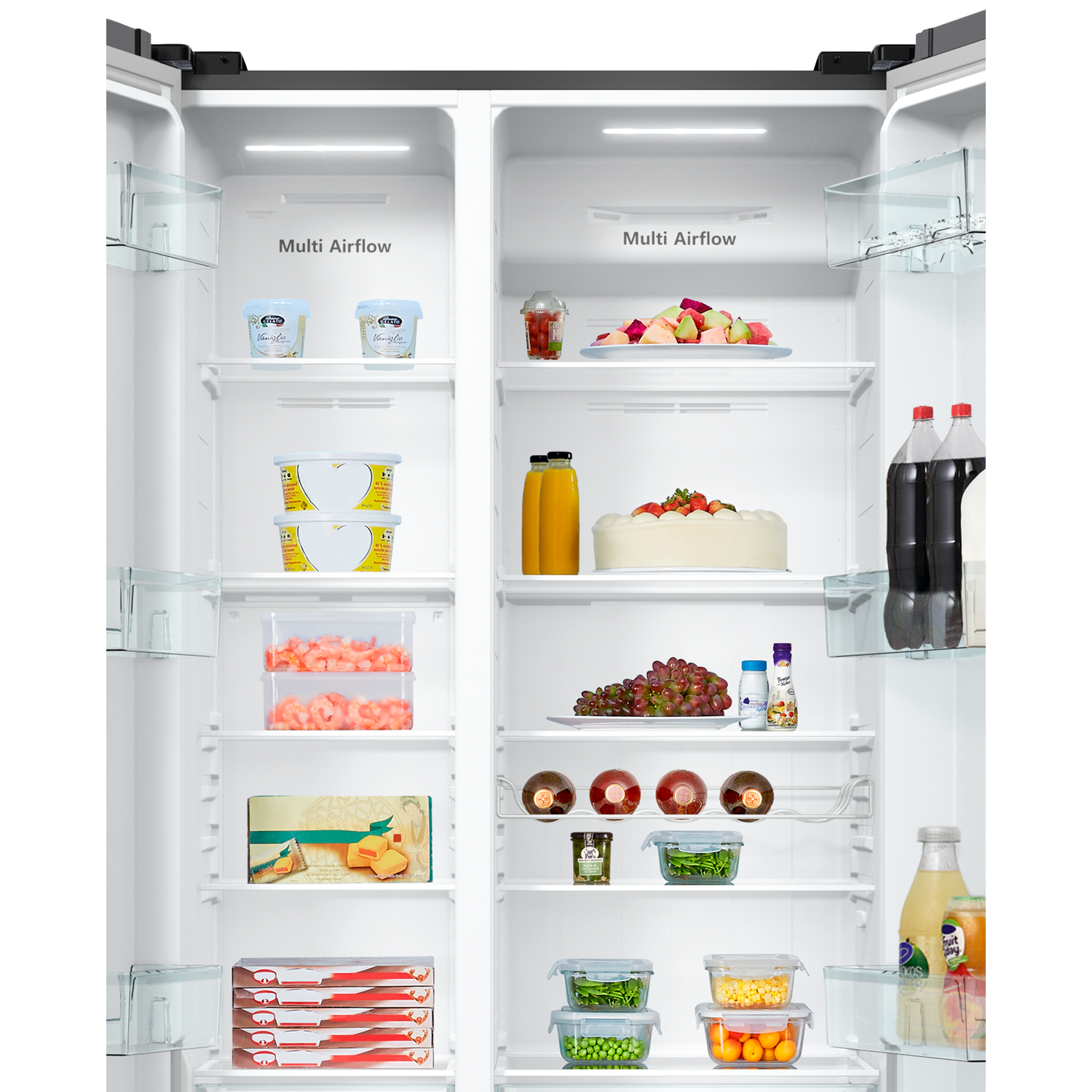 Open refrigerator filled with food: fruits, drinks, cake, grapes, and other items. The fridge has multiple shelves and drawers.