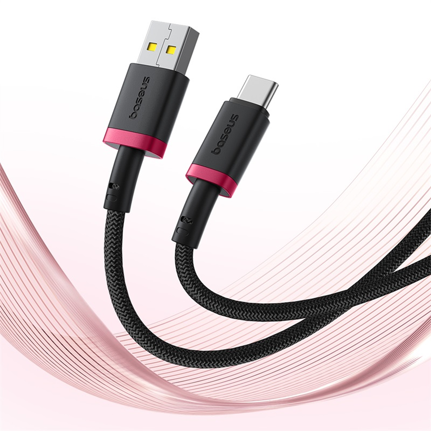 Cable USB negro con detalles rosas y la marca Baseus. Un extremo es USB, el otro USB-C. Fondo con líneas onduladas rosas.