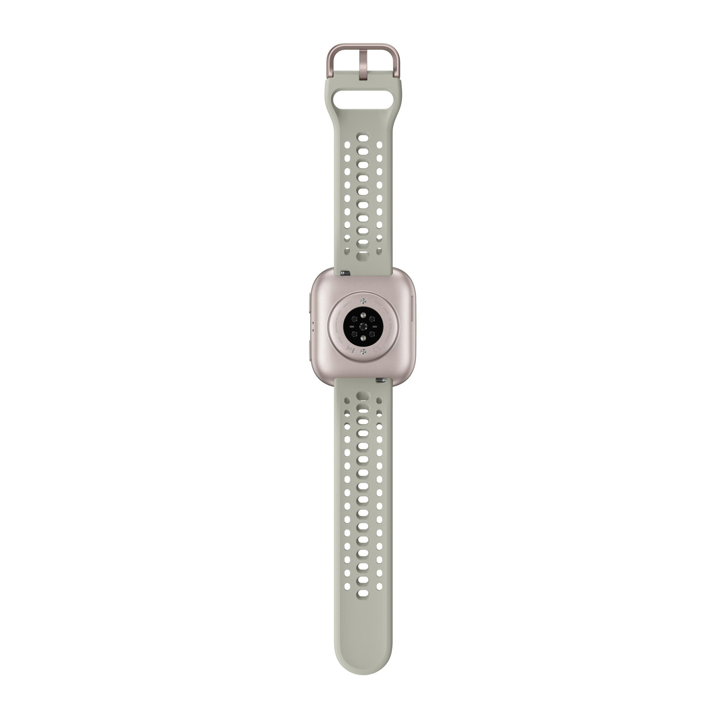 Rückseite einer Smartwatch mit hellgrünem Armband. Die Uhr ist hellrosa. Das Armband hat Löcher.