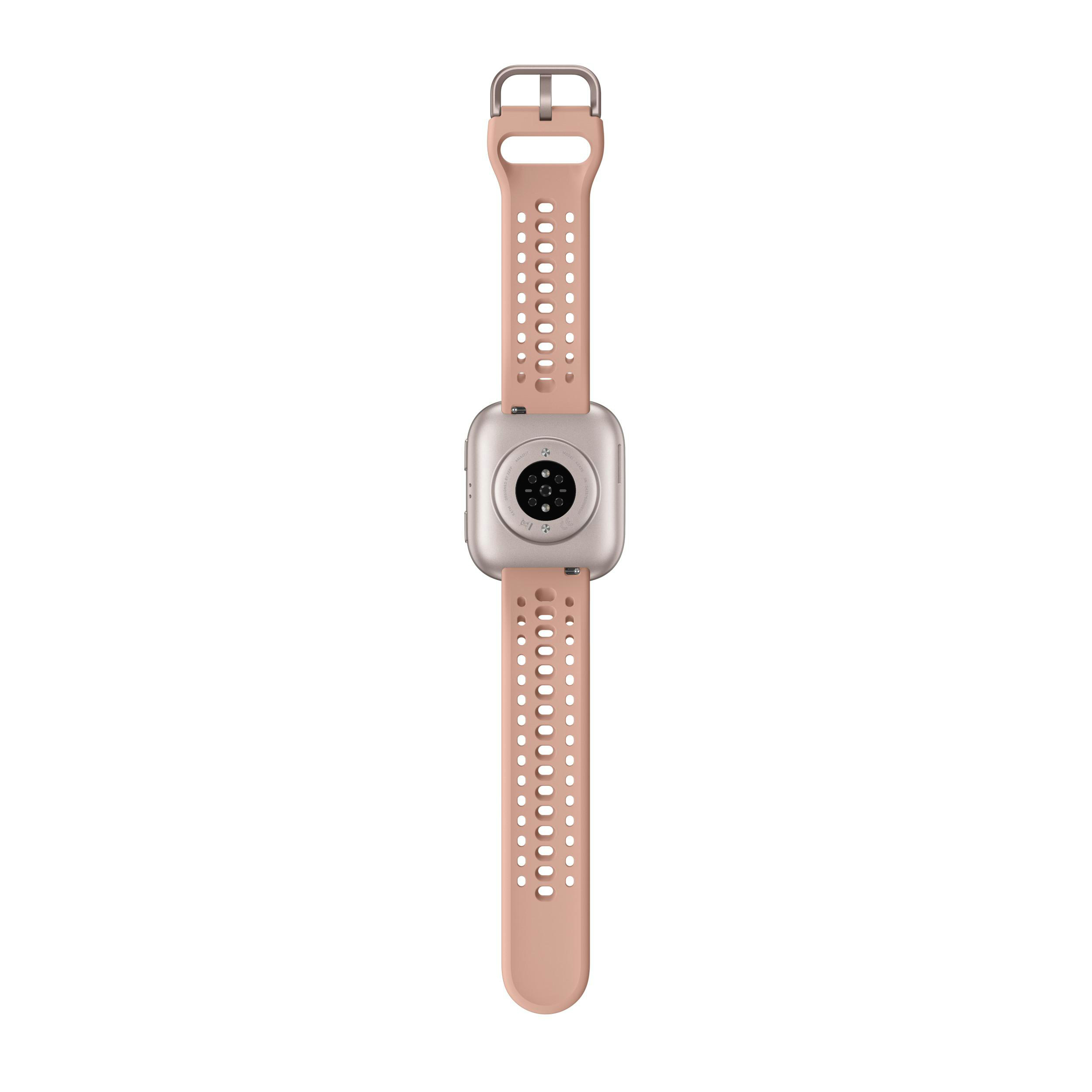 Eine roségoldene Smartwatch mit Pfirsichband ist zentriert. Das Band hat Löcher. Die Rückseite der Uhr zeigt Sensoren.