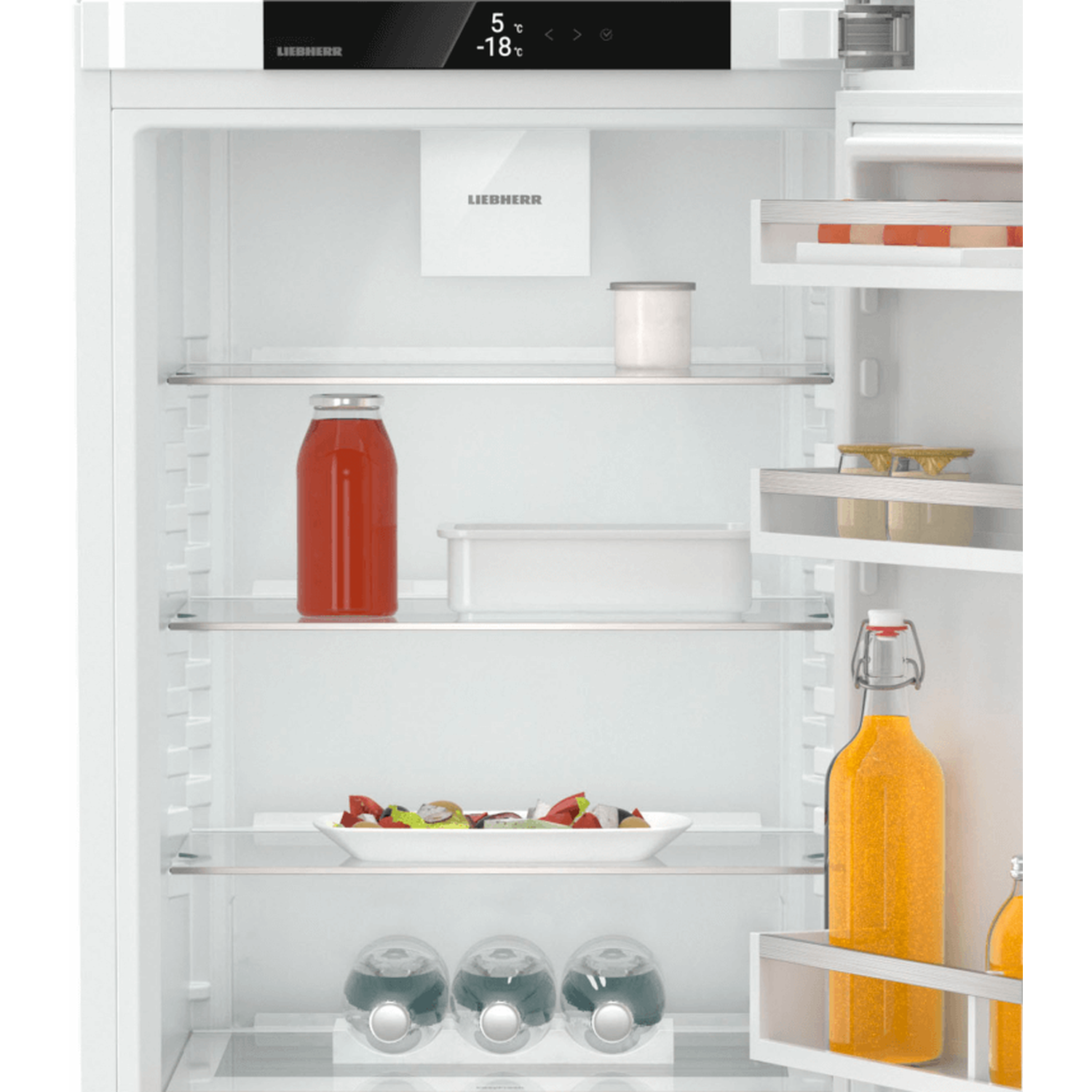 Open refrigerator with food. A jar of juice, a bottle of juice and some bottles of water are visible.