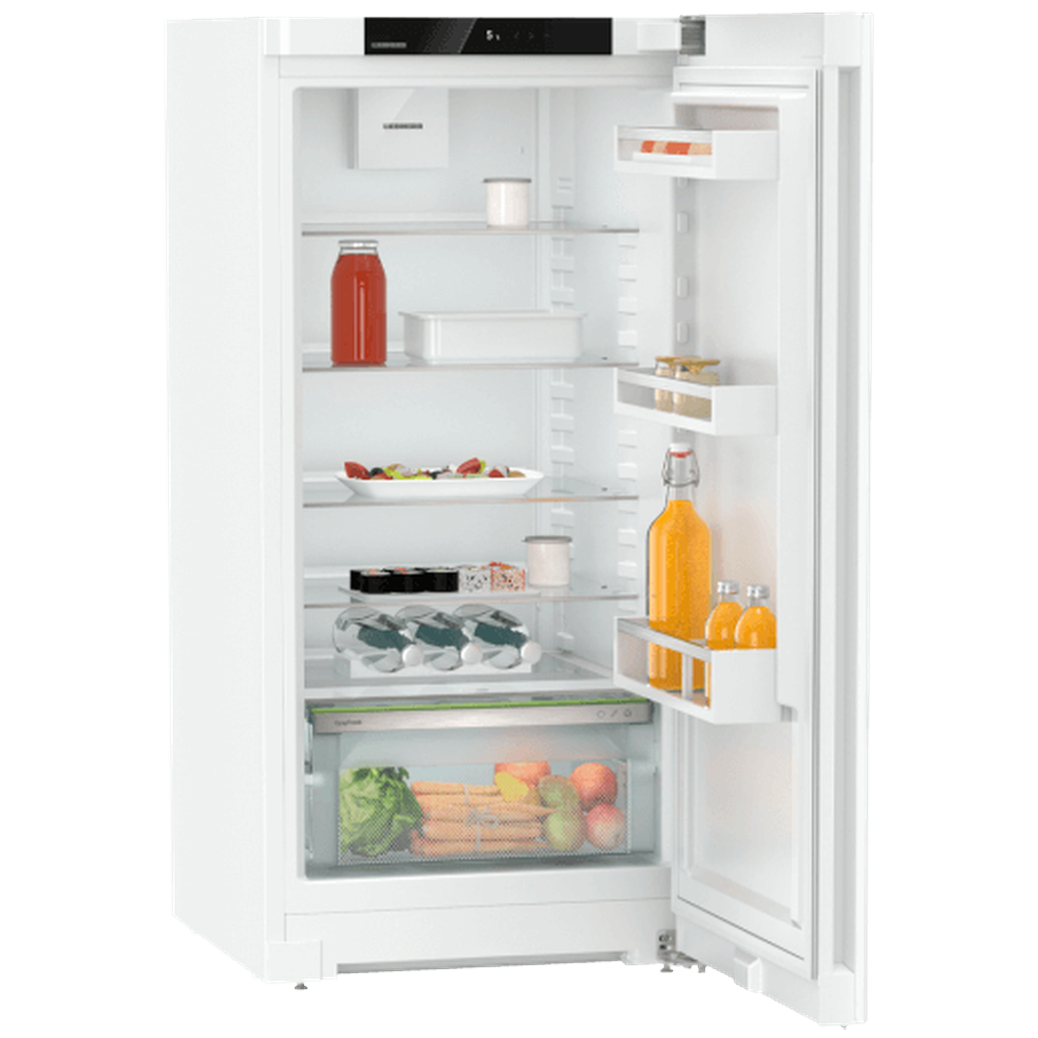 Open white refrigerator filled with food items. Includes juice bottles, fruits, vegetables, and containers on shelves. Door is ajar.