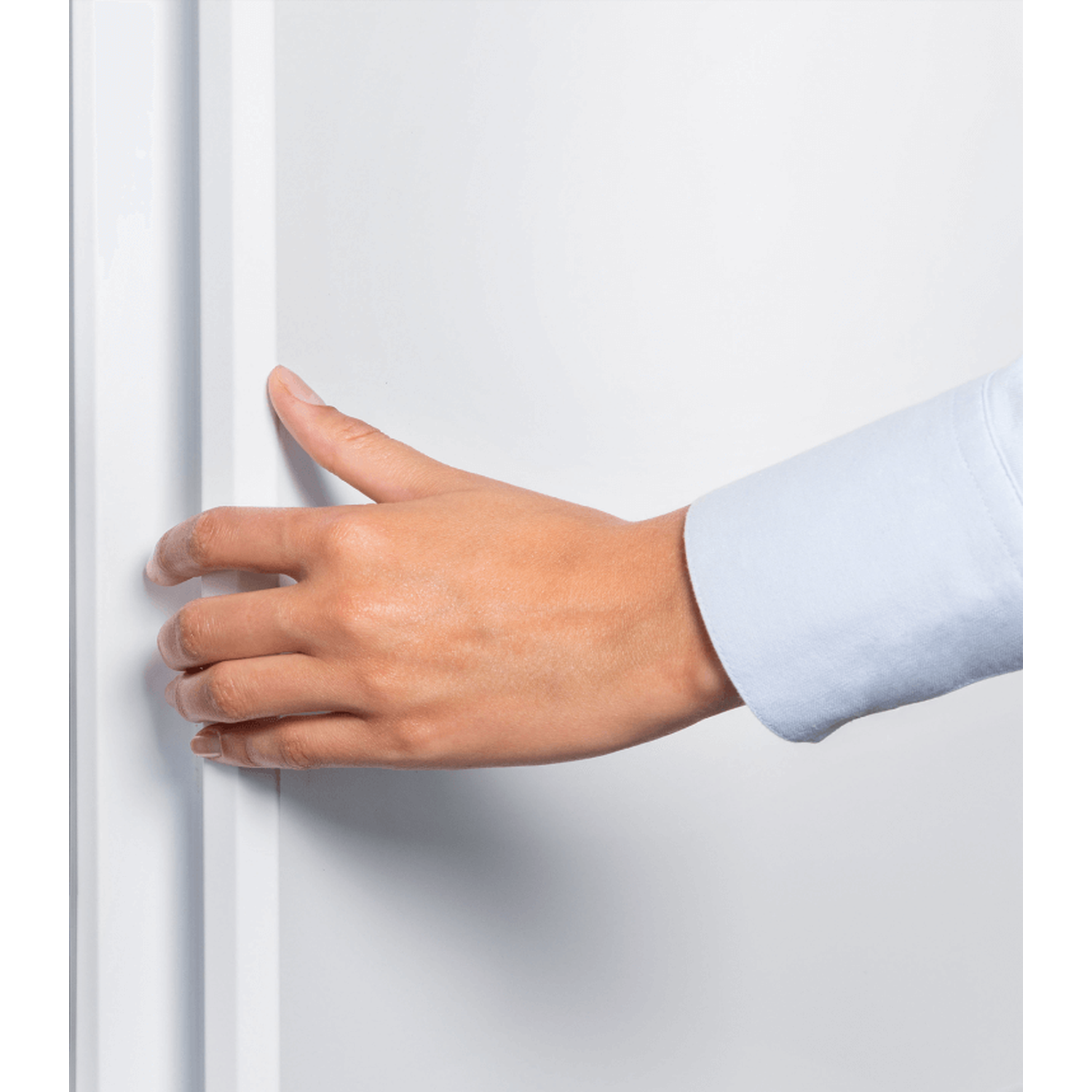 A hand in a light blue shirt sleeve is grasping a white surface. The hand is brown-skinned.