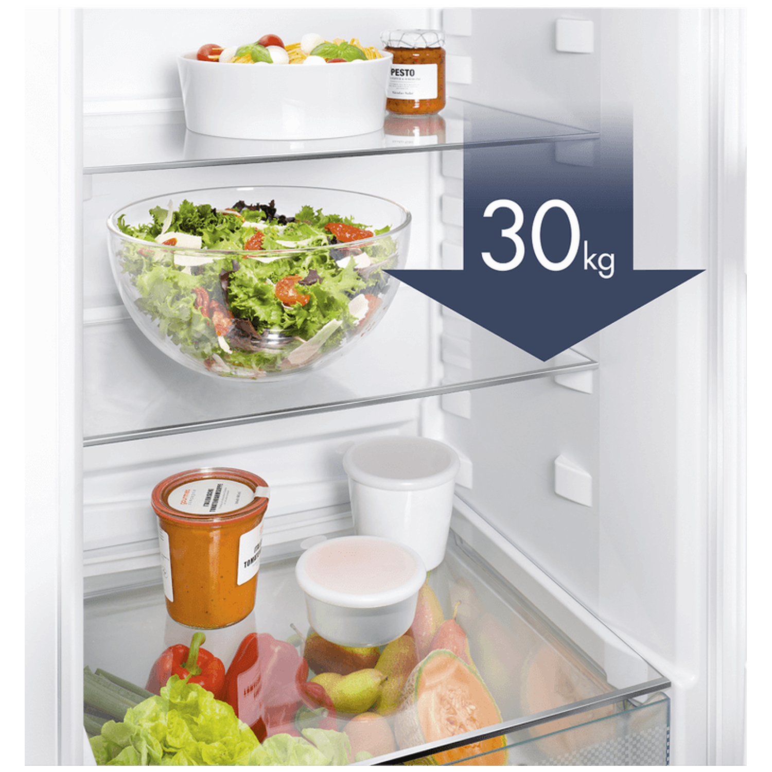 Inside a refrigerator, salads, jars, and fruits are visible on different shelves. A sign indicates a 30kg weight limit.