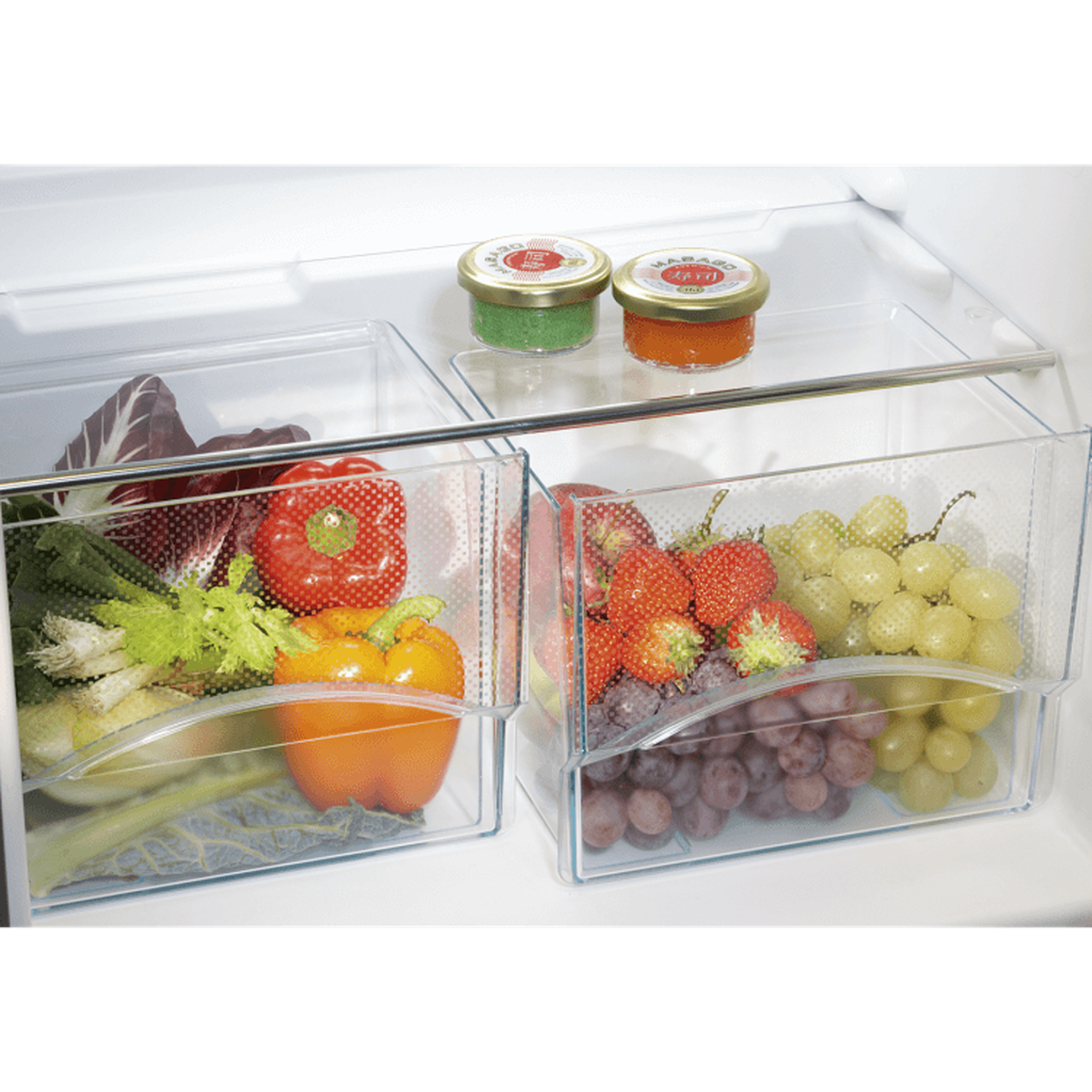 Inside a fridge: vegetables, fruits, and jars. Peppers, strawberries, grapes, lettuce, and celery are visible.