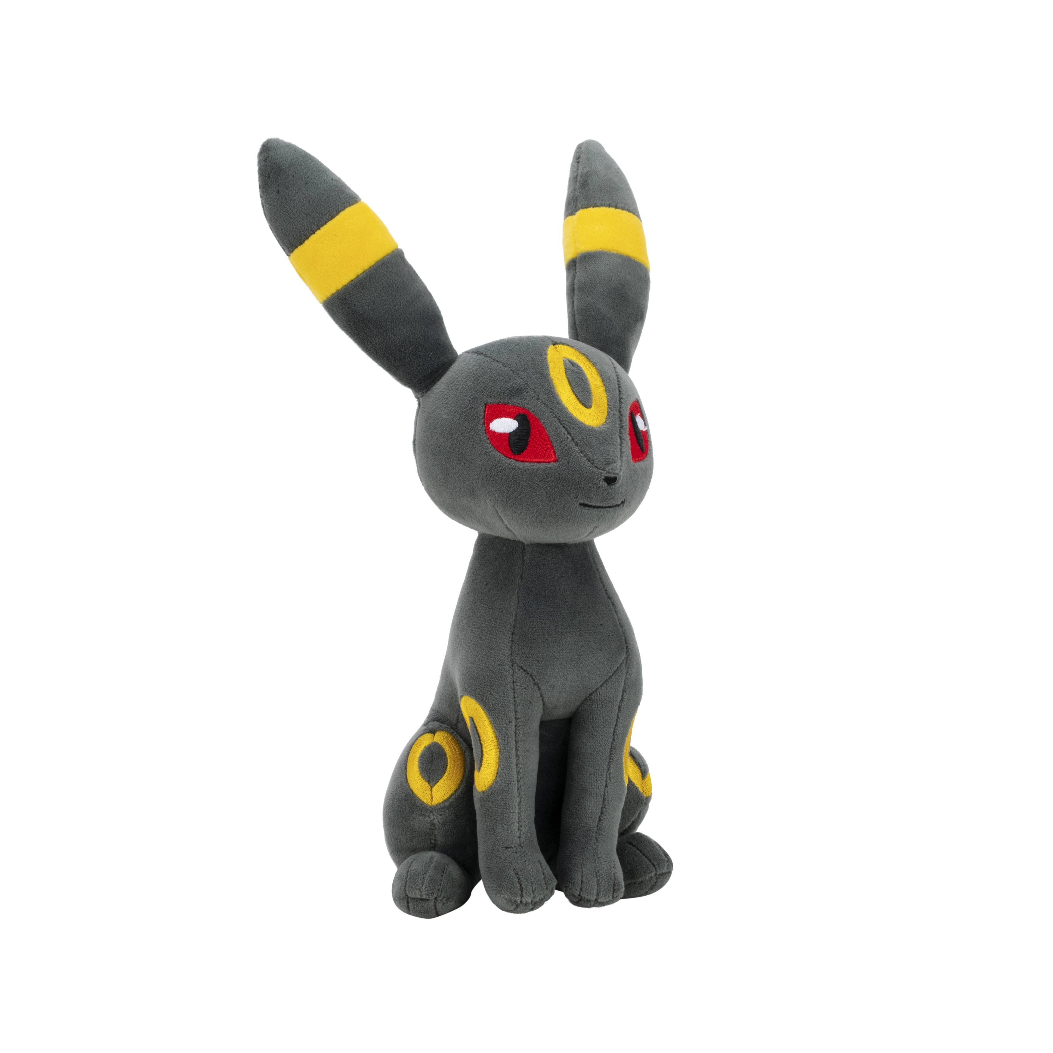 Ein Plüschtier von Umbreon, dunkelgrau mit gelben Markierungen. Es hat rote Augen und sitzt.
