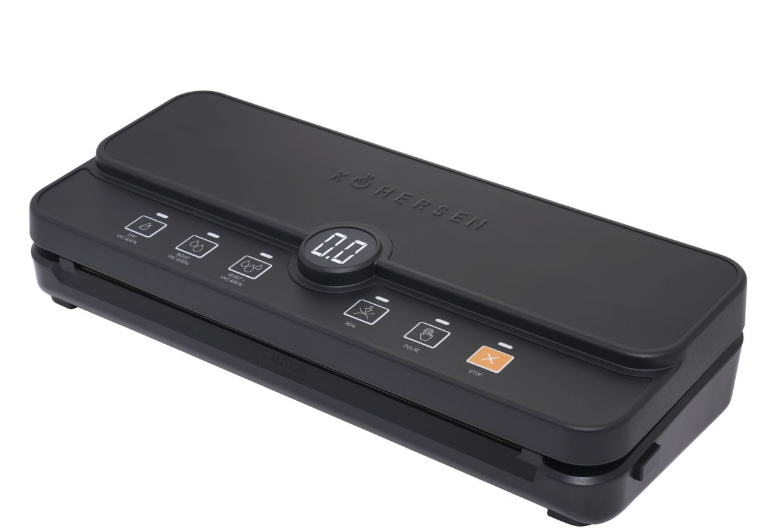 Czarna zgrzewarka próżniowa z przyciskami i wyświetlaczem cyfrowym. Marka 'KÖHERSEN' u góry. Przyciski to 'seal' i 'stop'.