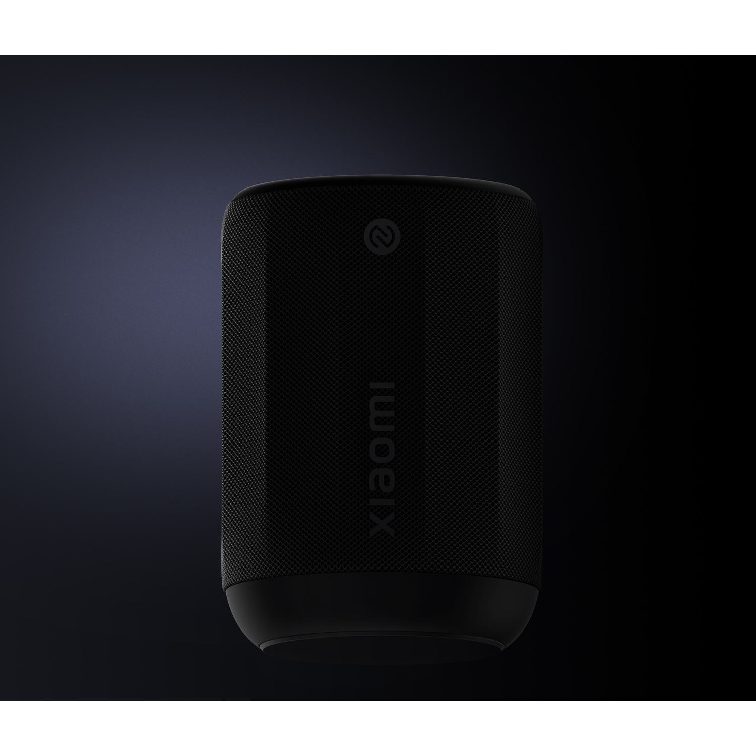 A black Xiaomi smart speaker. The speaker is cylindrical and has the word 'Xiaomi' printed vertically. A logo is visible.
