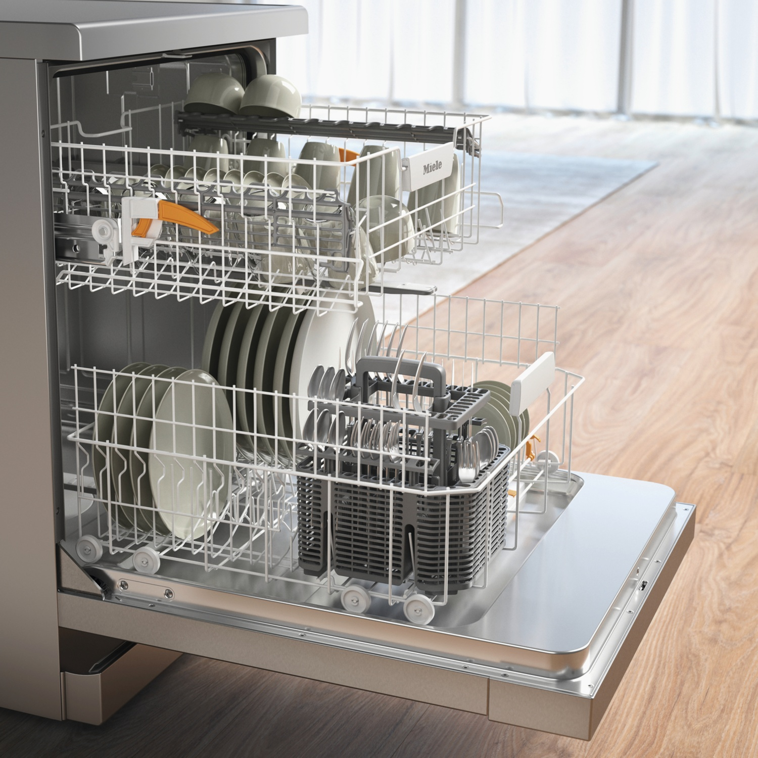 Open dishwasher with dishes inside. Plates, cups, cutlery, and rack visible. Wooden floor in the background.