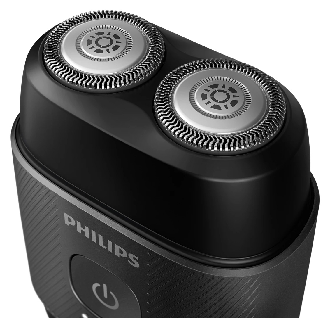 Zbliżenie czarnej golarki elektrycznej Philips. Widoczne są dwie srebrne głowice obrotowe. Nazwa marki i przycisk zasilania znajdują się na uchwycie.