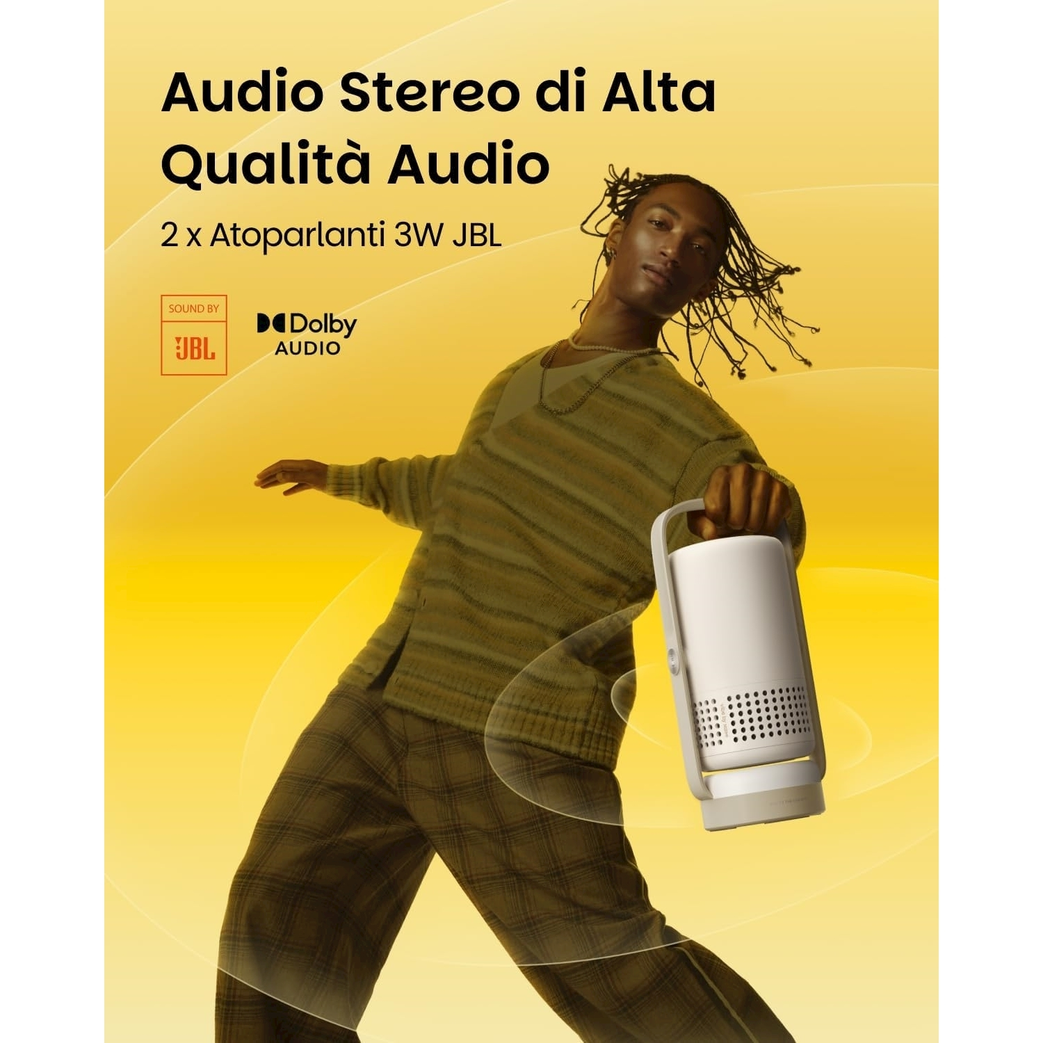 Una persona tiene in mano un altoparlante bianco. Lo sfondo è giallo, con testo sulla qualità audio e i loghi JBL e Dolby Audio.