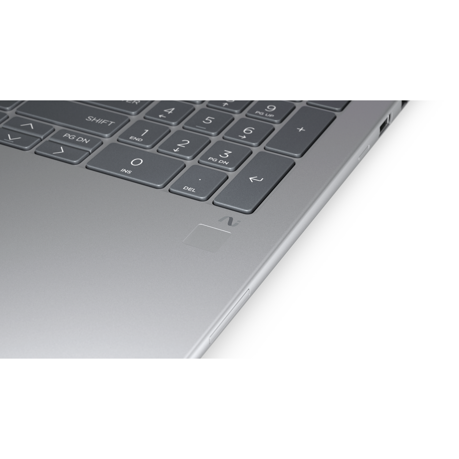 Close-up of a laptop keyboard. Gray keys with white letters and numbers. A fingerprint sensor is visible. The laptop is silver.