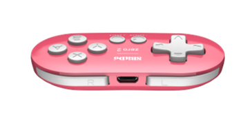 Ein pinkfarbener und weißer Gamecontroller. Er hat Knöpfe, ein Steuerkreuz und einen Ladeanschluss. Der Markenname ist sichtbar.