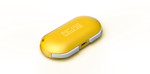 Ein gelbes und weißes, pillenförmiges Gerät liegt auf einer weißen Oberfläche. Es hat einen USB-Anschluss und Text.