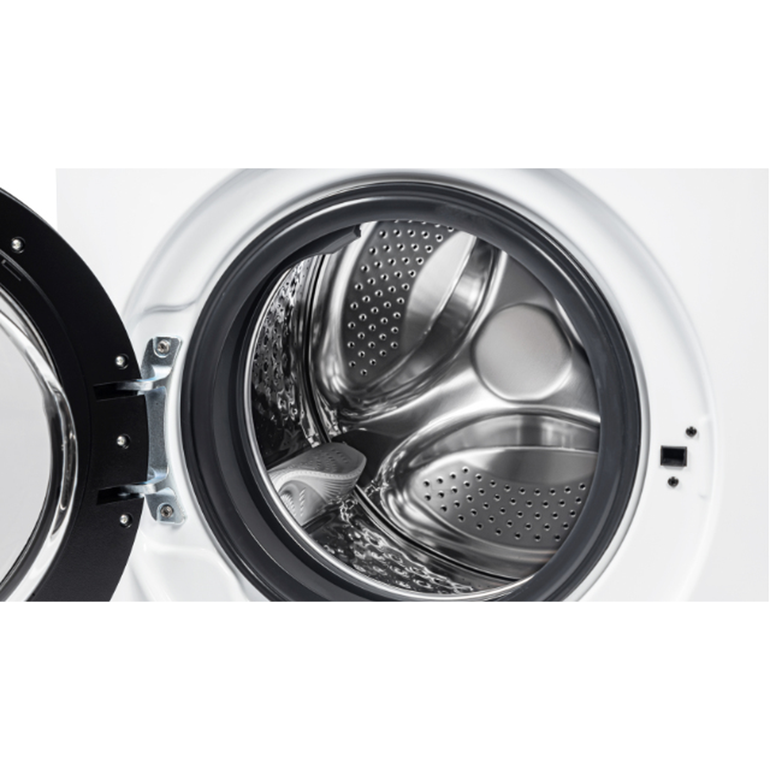 Open washing machine drum. Stainless steel interior, with a black rubber seal. The door is ajar, showing the inside.
