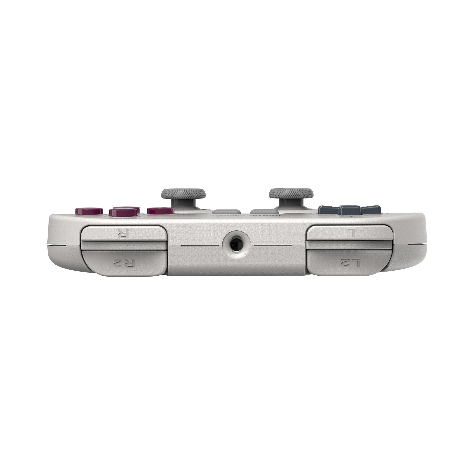 Seitenansicht eines weißen Handheld-Gaming-Controllers. Es hat graue Knöpfe und einen schwarzen Anschluss.