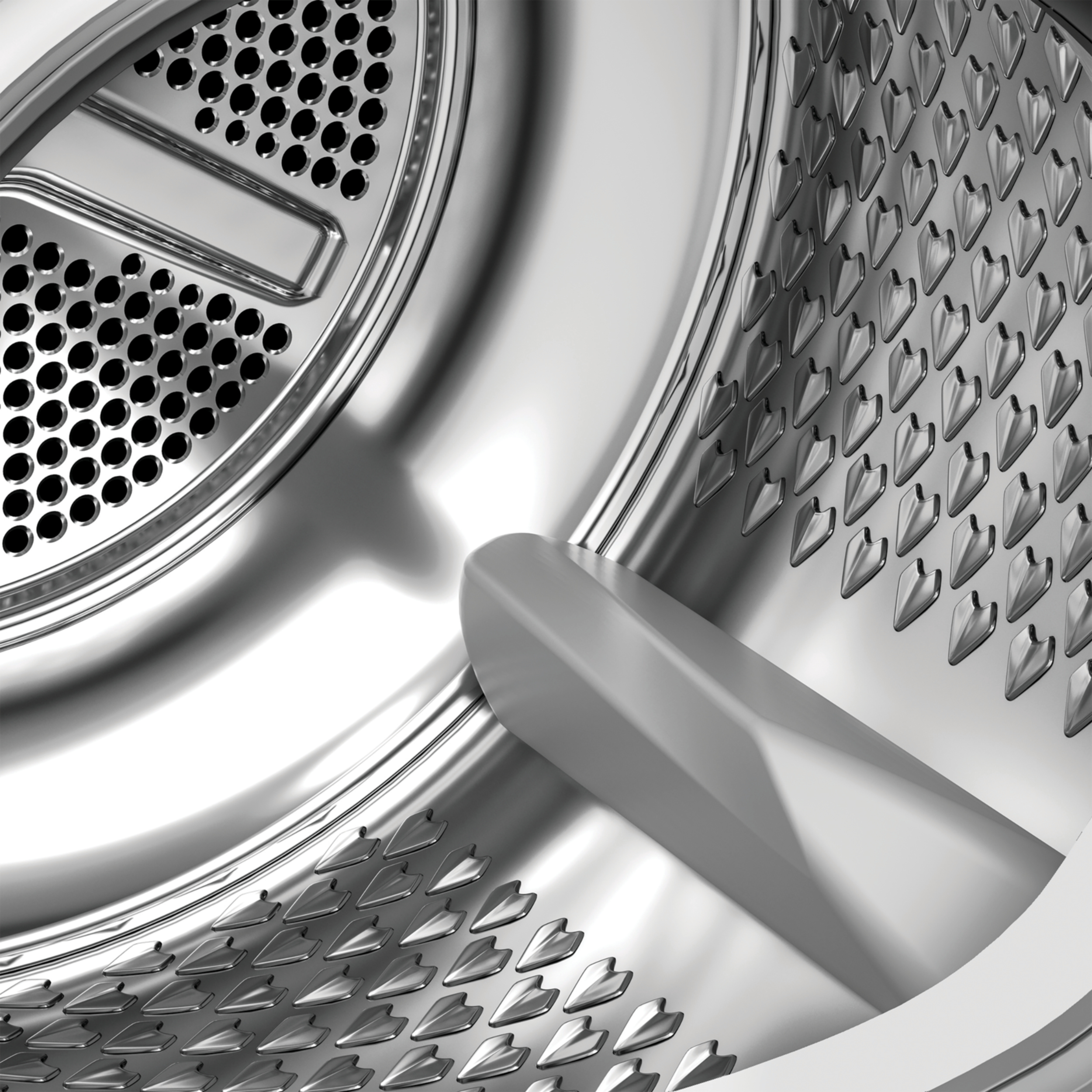 Zbliżenie wnętrza bębna pralki. Perforowany metal, z centralnym prętem, odbijający światło.