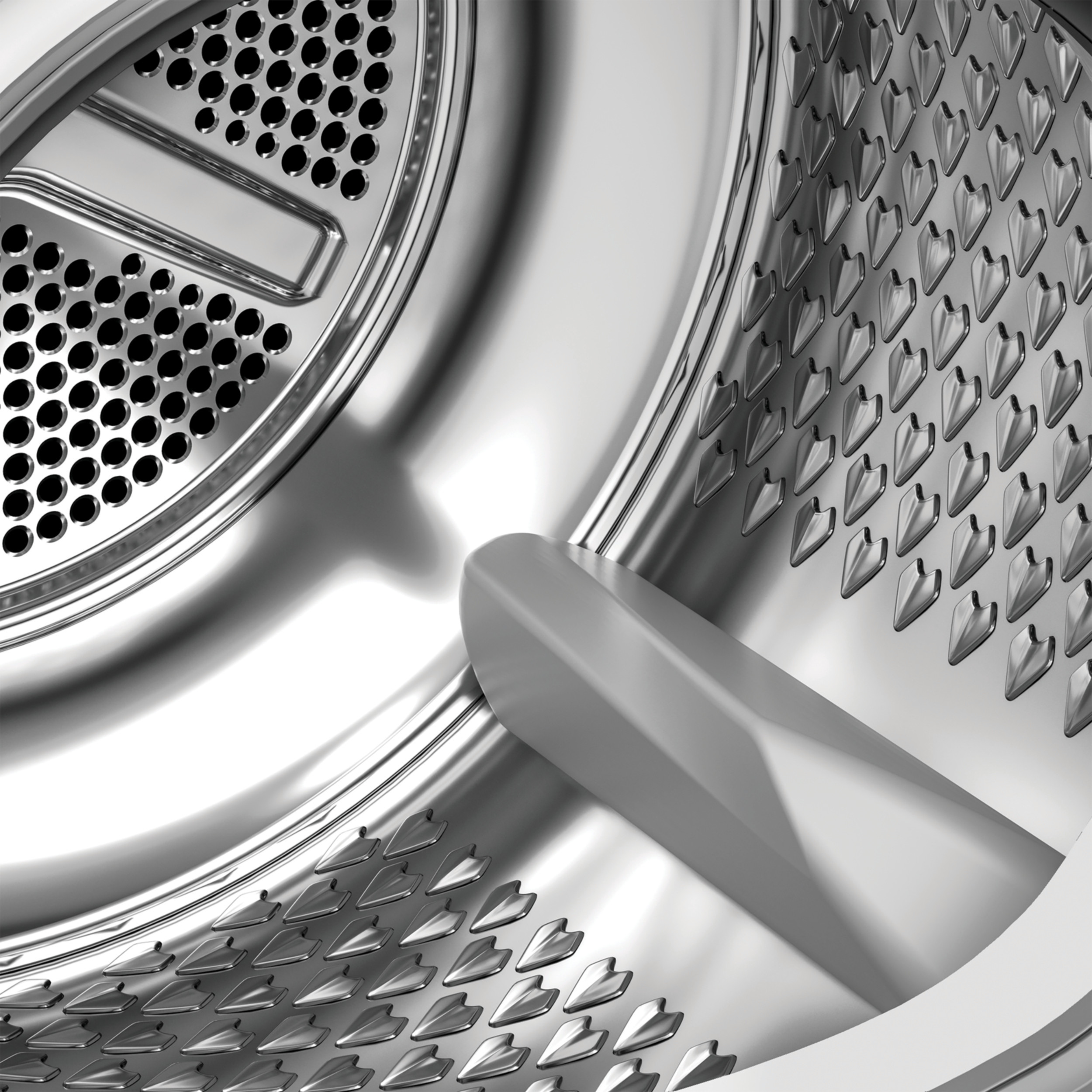 Zbliżenie wnętrza metalowego bębna pralki z otworami i centralnym drążkiem.