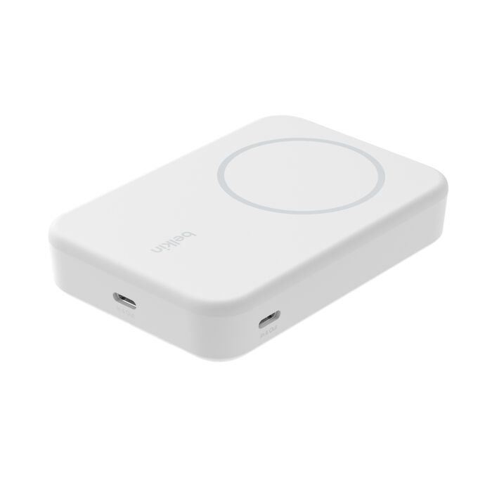 Un cargador inalámbrico blanco de Belkin. Tiene un área de carga circular y dos puertos laterales. El fondo es blanco.