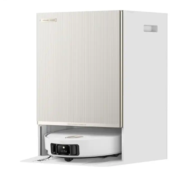 Biały odkurzacz automatyczny znajduje się pod białymi, żebrowanymi drzwiami. Drzwi są częścią większej białej struktury w kształcie pudełka.