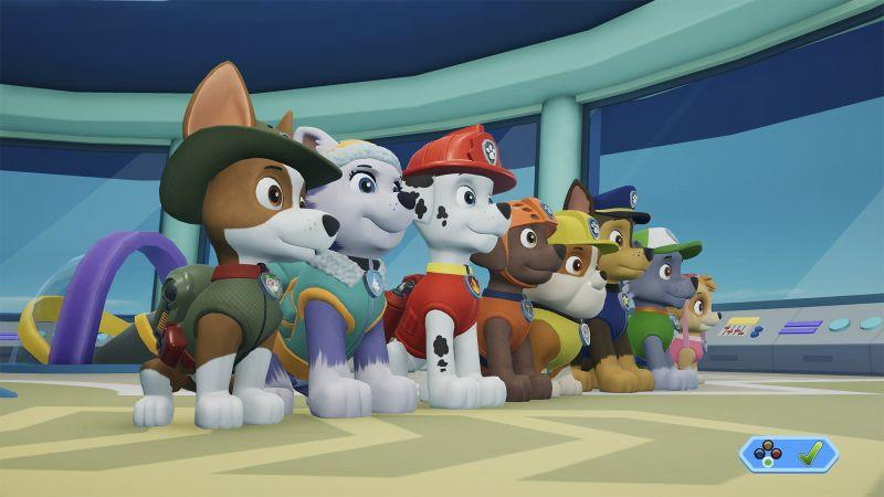 Das Paw Patrol-Team steht zusammen. Jeder Welpe trägt eine Uniform. Im Hintergrund sind Fenster und Bedienfelder zu sehen.