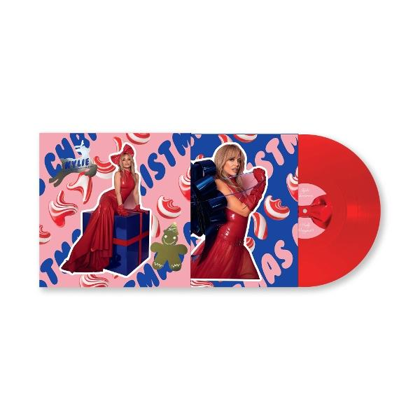 Albumcover: Frau in rotem Kleid mit roter Schallplatte. Rosa und blauer Hintergrund mit Weihnachtselementen.
