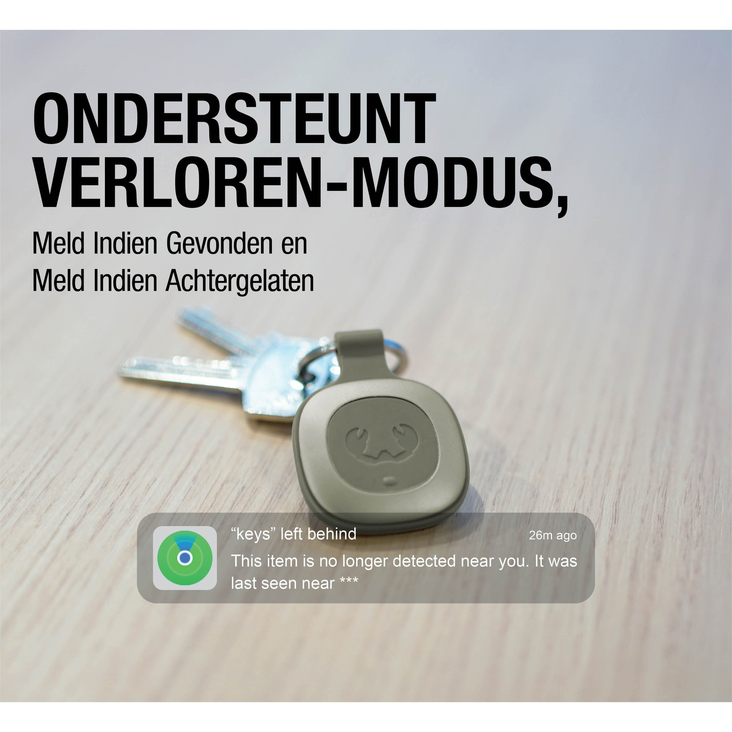 Keys and a tracker on a wooden surface. Text in Dutch says 'lost mode' and other related phrases. A notification is also visible.