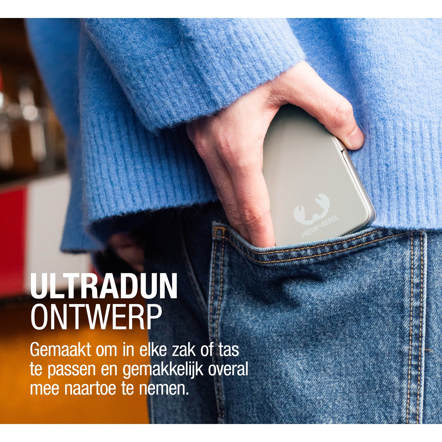 A person in a blue sweater puts a silver device with a logo into a jean pocket. The text 'ULTRADUN ONTWERP' is visible.
