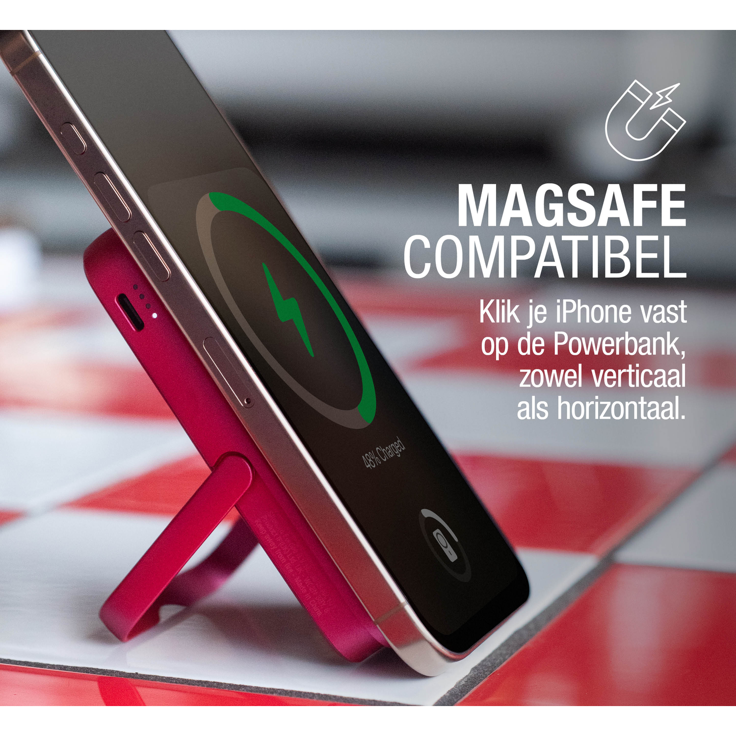 A phone is charging on a pink power bank. The phone displays a charging icon and the text '48% Charged'.