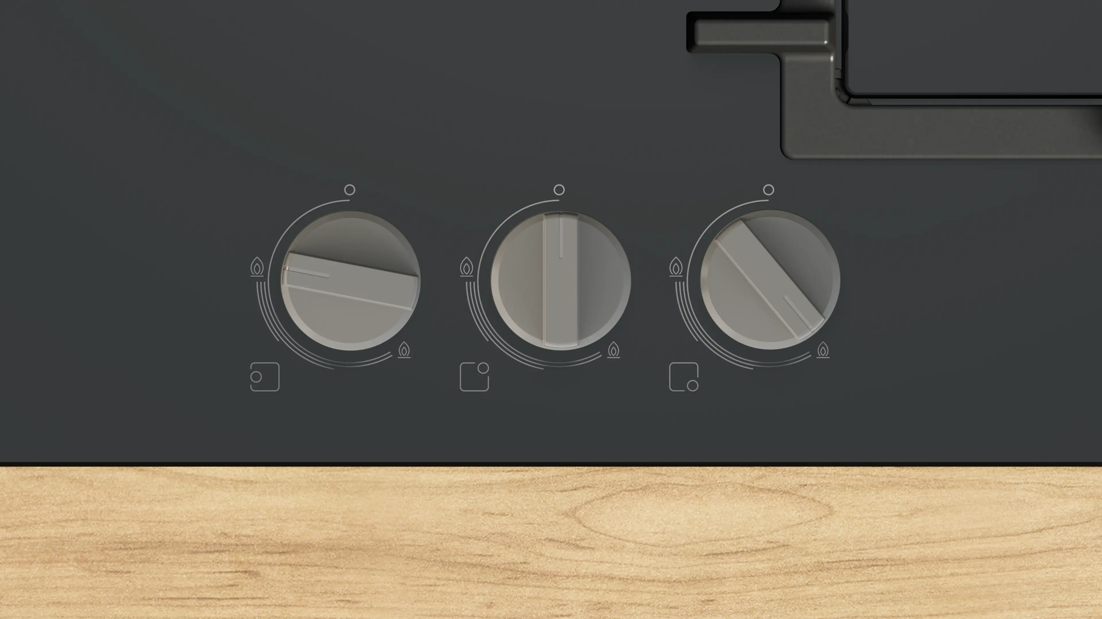 Primer plano de una estufa con tres perillas. Las perillas son grises y la estufa es gris oscuro. Madera en la parte inferior.