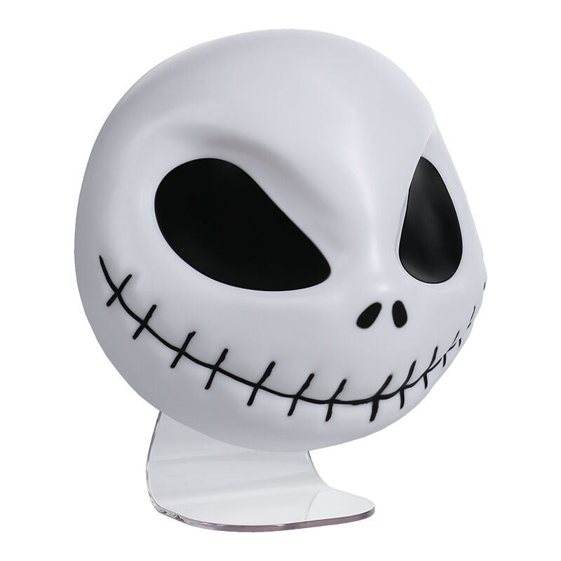 Una cabeza blanca de Jack Skellington con ojos negros y boca cosida, sobre un soporte transparente. La cabeza es redonda y lisa.
