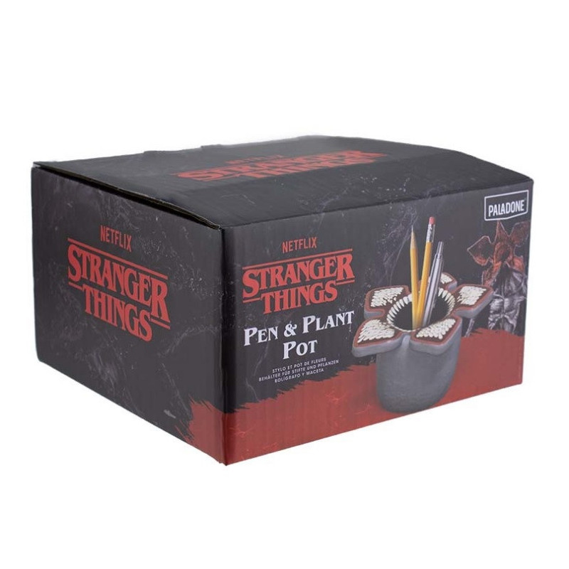 Un juego de bolígrafos y macetas de Stranger Things. La caja es negra con texto rojo. La maceta tiene forma de Demogorgon.