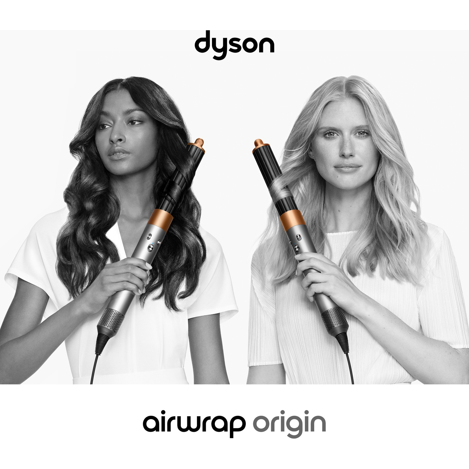 Two women, one with dark hair, the other blonde, hold Dyson Airwrap stylers. The Dyson logo and 'airwrap origin' text are displayed.