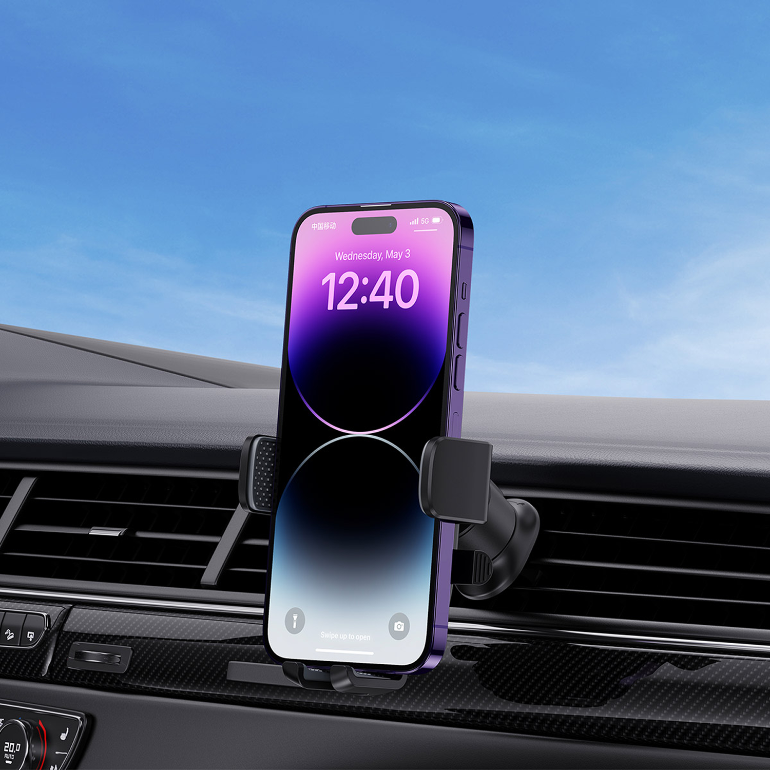 Un iPhone morado muestra las 12:40 en la pantalla, montado en un soporte de ventilación de coche. Cielo azul al fondo.