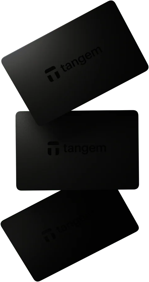 Drei schwarze Tangem-Karten sind in verschiedenen Winkeln vor einem schwarzen Hintergrund angeordnet. Das Tangem-Logo ist sichtbar.